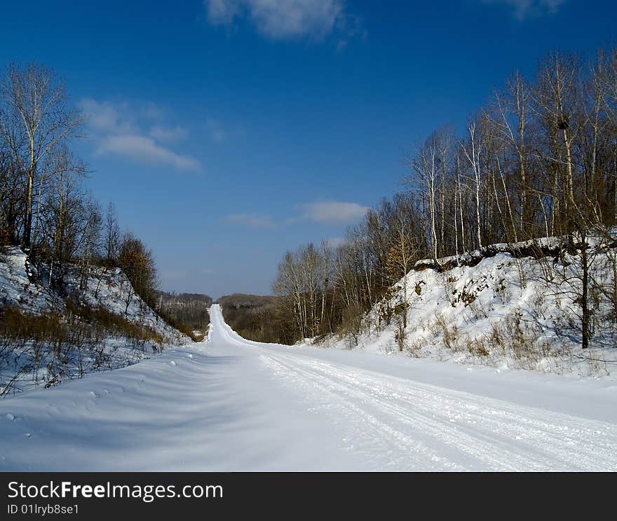 The Winter landscape road coverring snow in wood. The Winter landscape road coverring snow in wood