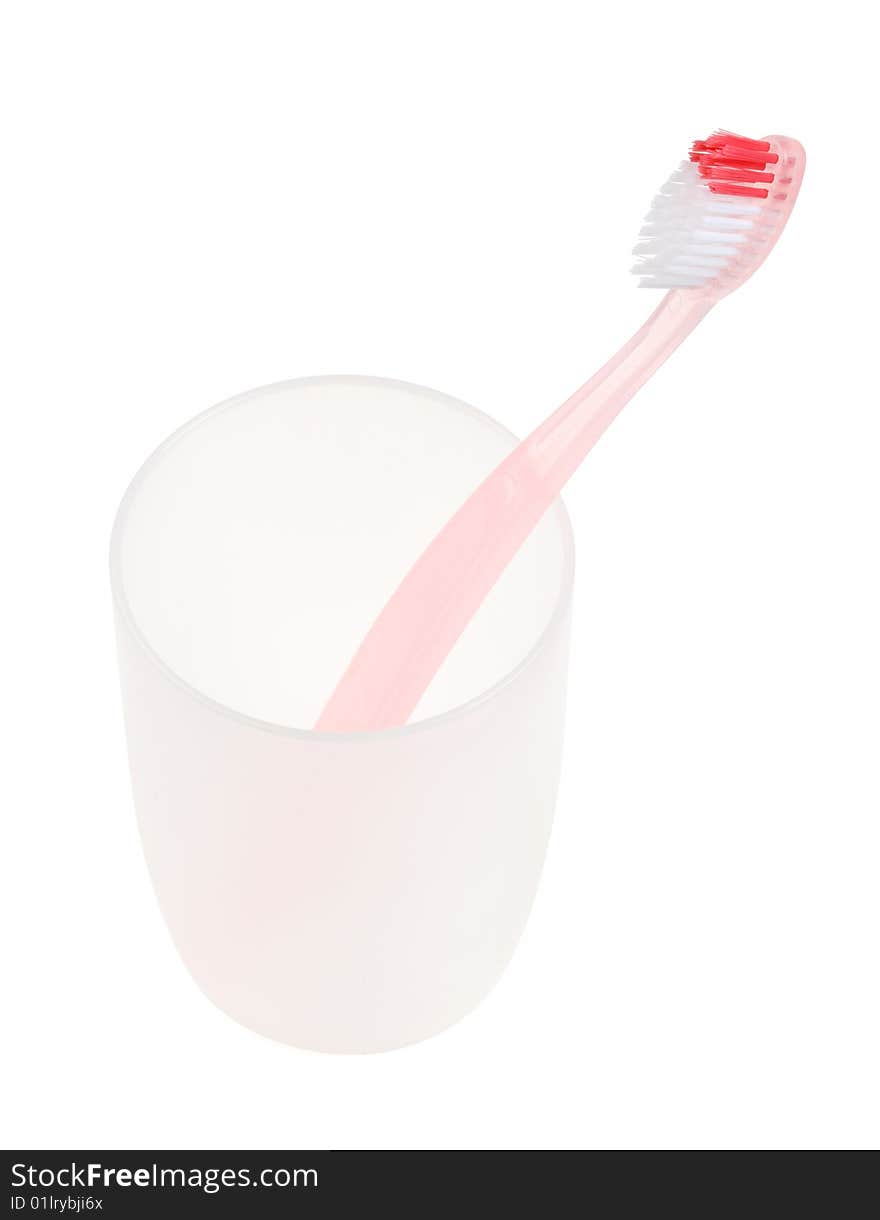 Pink toothbrush in glass. With clipping path.