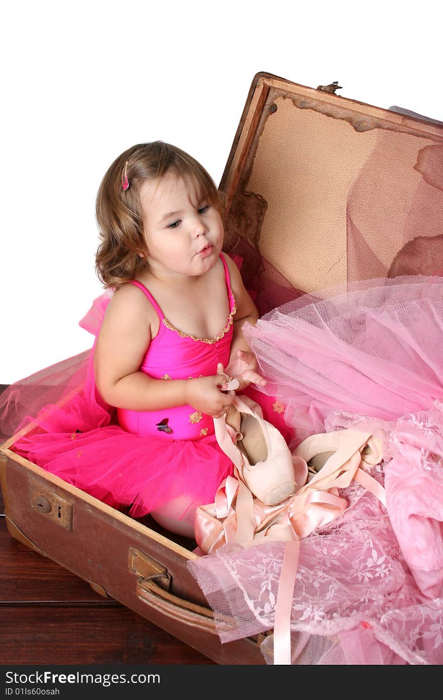 Little girl with short hair wearing a bright pink ballet outfit