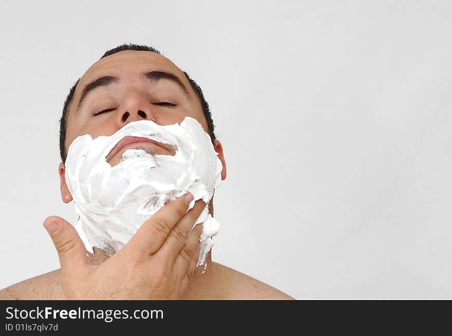 Man shaving isolated on gray background