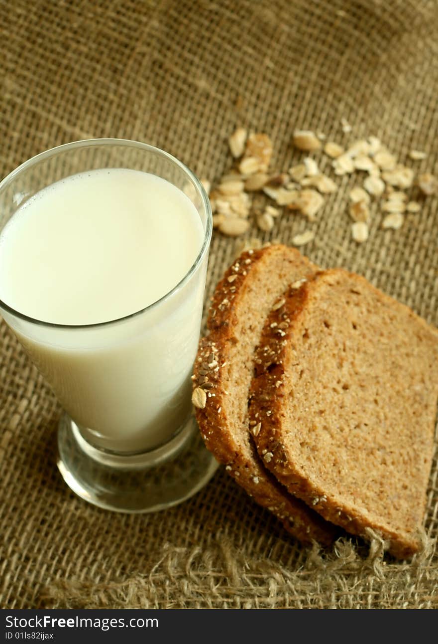 Glass of milk and bread on a sacking