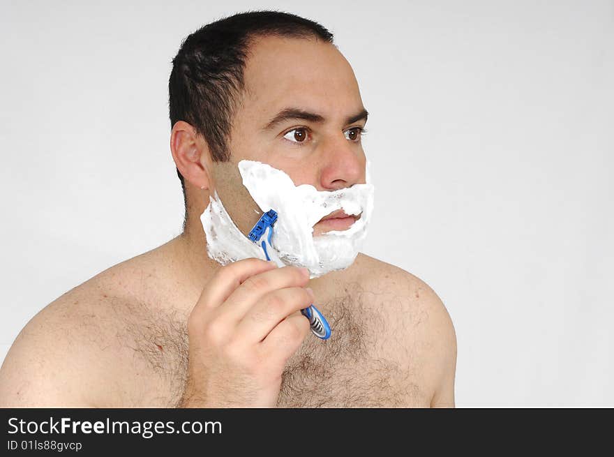 Man shaving isolated on gray background