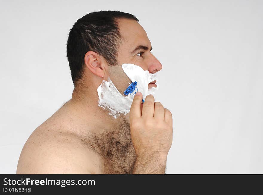 Man shaving isolated on gray background