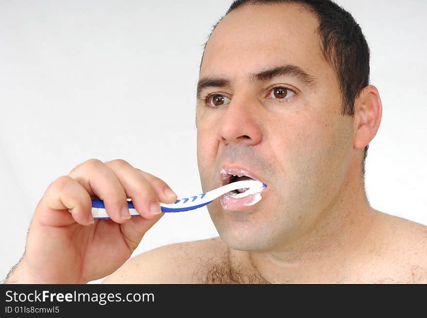 Man brushing his teeth isolated on gray background