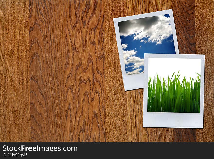 A polaroid frames on a wood surface