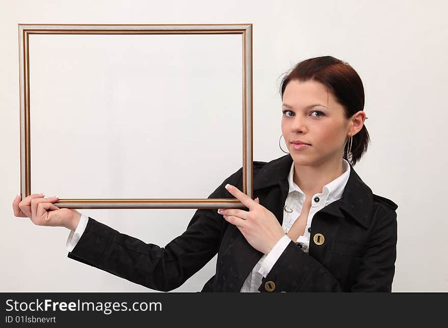 Beautiful girl in white blouses holds picture  frame. Beautiful girl in white blouses holds picture  frame