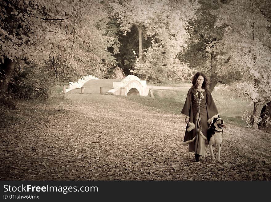 Lady in medieval dress and dog in the forest. Lady in medieval dress and dog in the forest