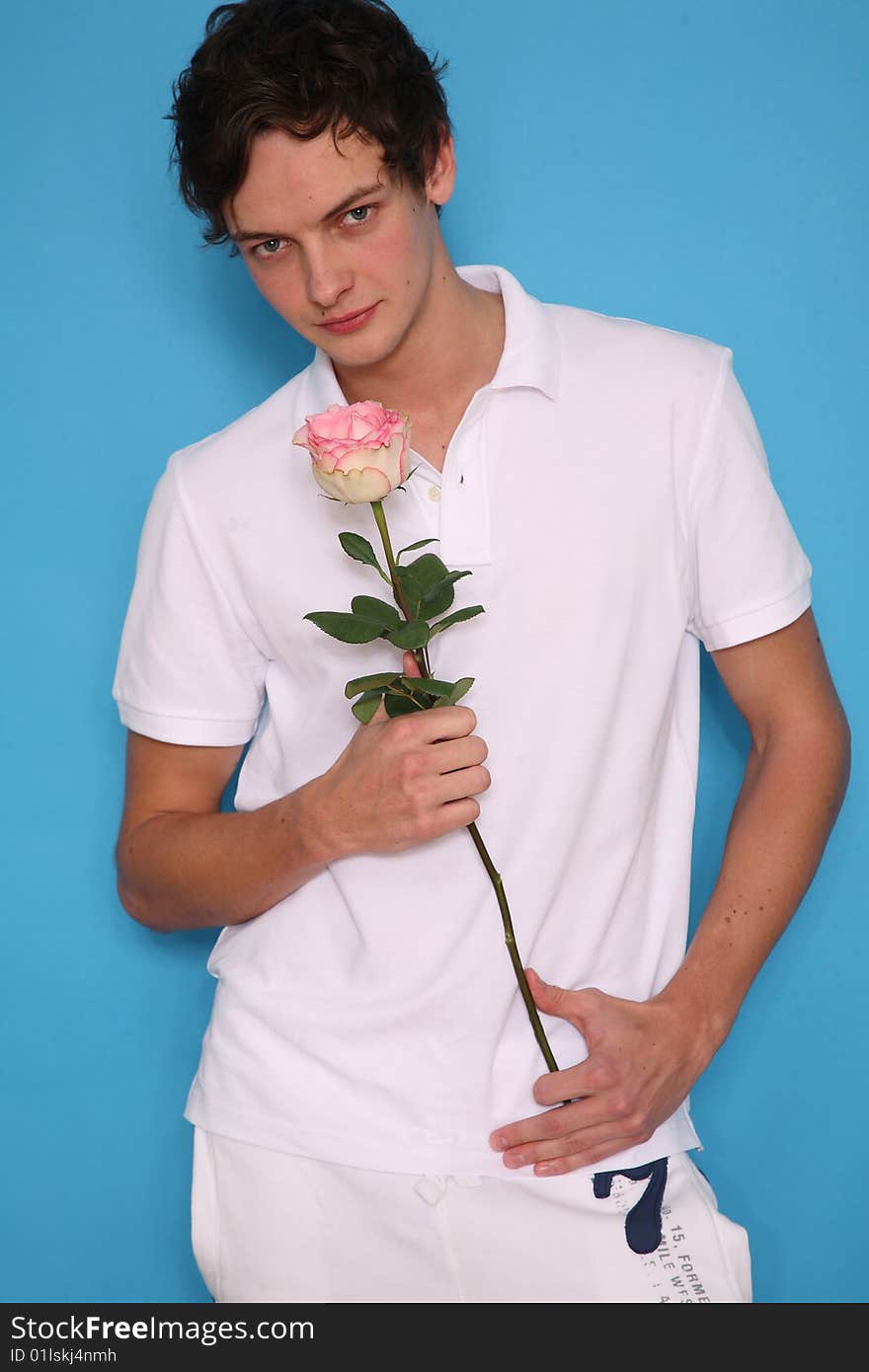 young man with rose looking seriously