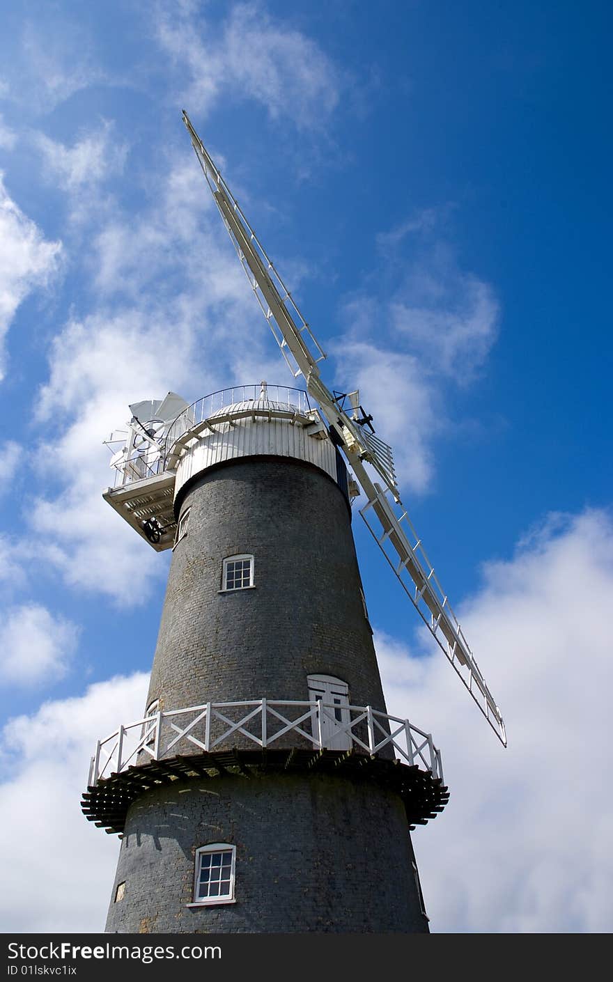 Traditional windmill set against blue sky. Traditional windmill set against blue sky