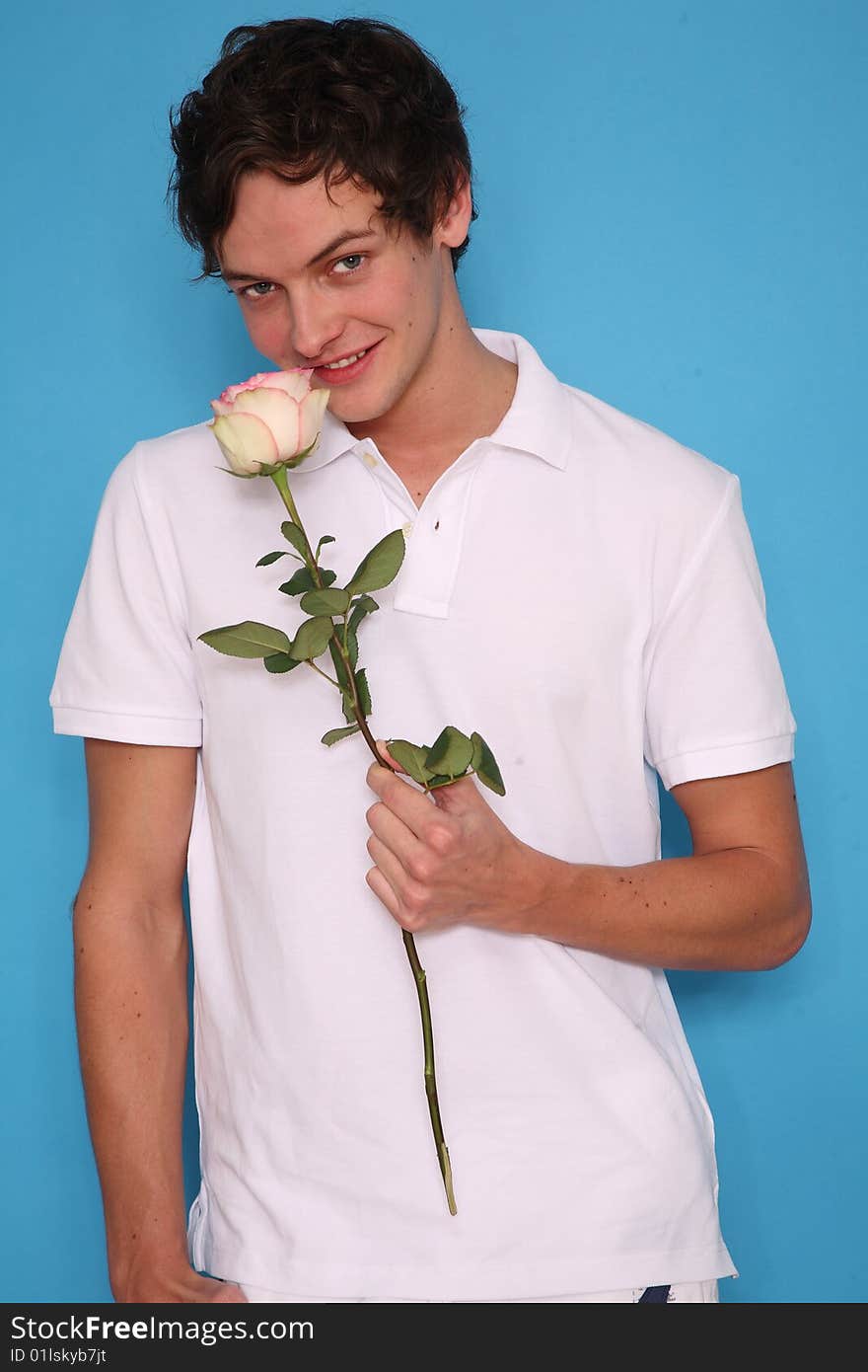 young man with rose standing and smling