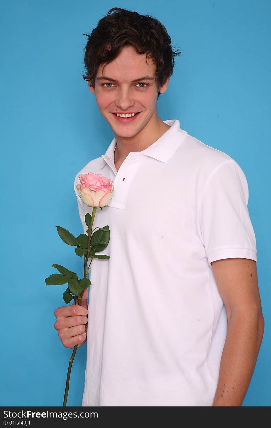 young man with rose standing and smiling