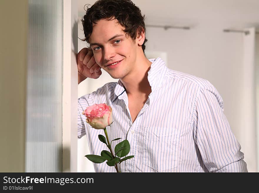 young man with rose standing and smilied