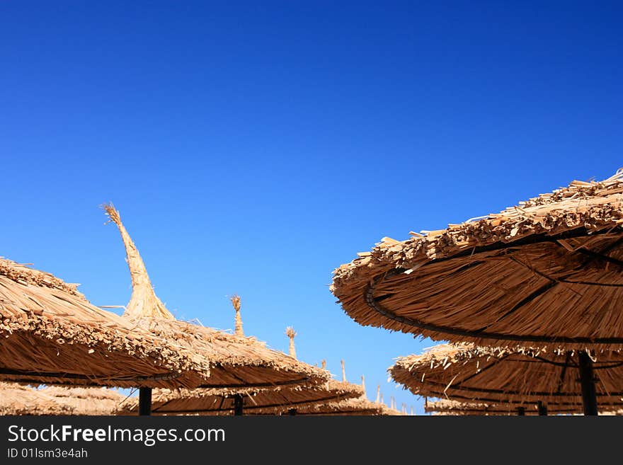 Blue sky and umbrellas on the beach(captured with Canon 400d, Tamron 17-50/2.8, ISO 100, RAW>TIFF>JPEG 1)