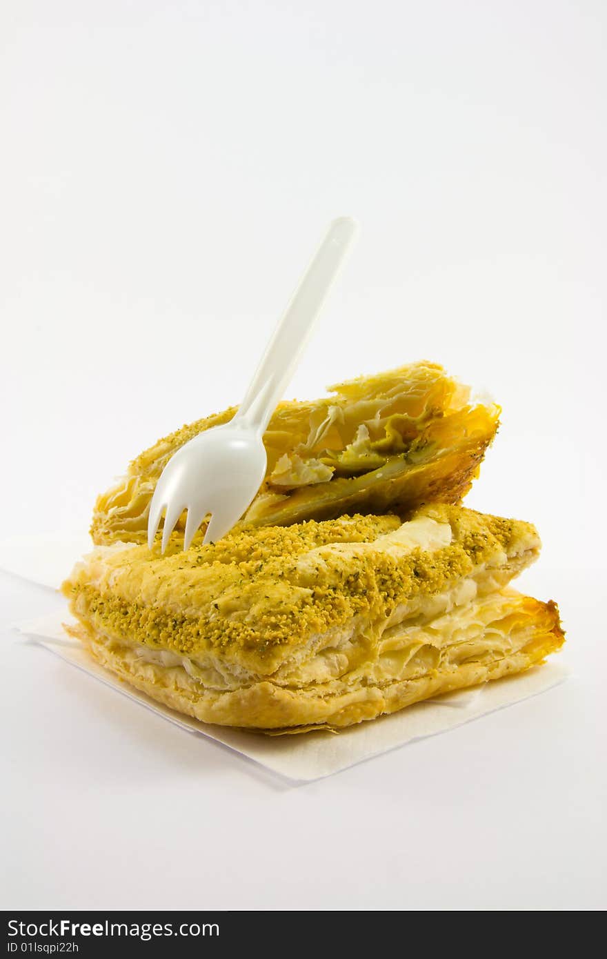 Single chicken curry pasty with plastic white fork on a white background. Single chicken curry pasty with plastic white fork on a white background