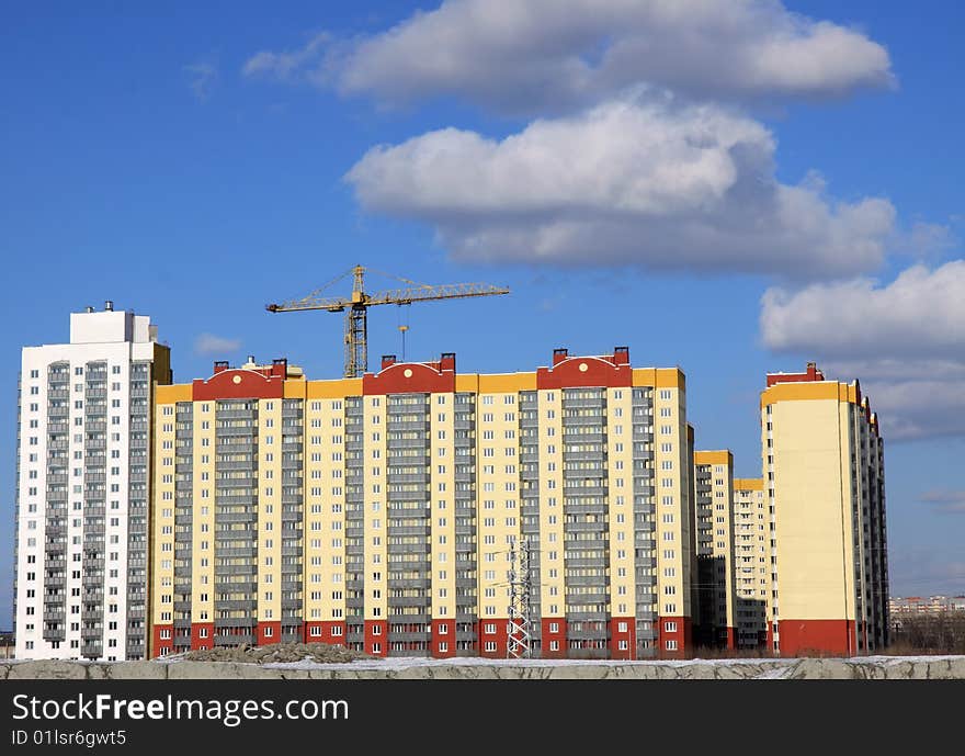 A under construction house on a background of the blue sky