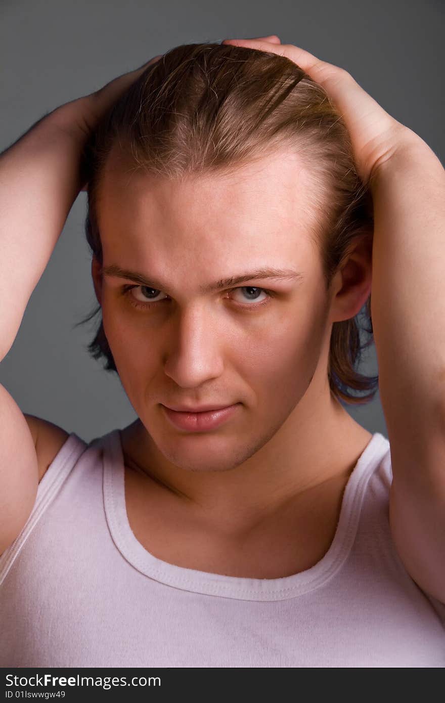 �lose up portrait of blond man over gray background