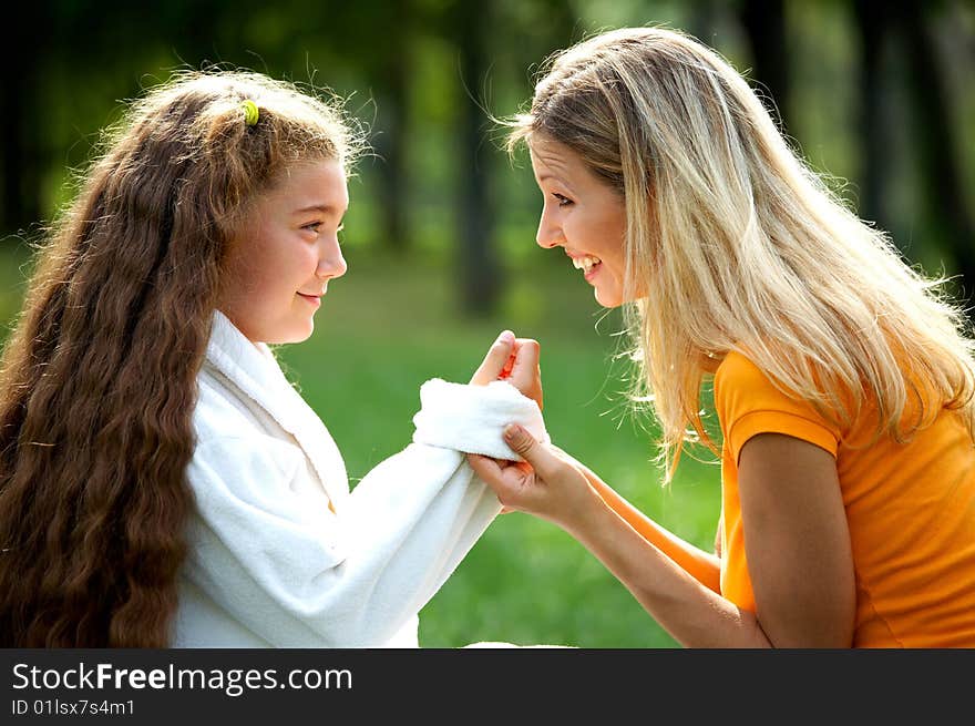 Happy mom and daughter smiling outdoors