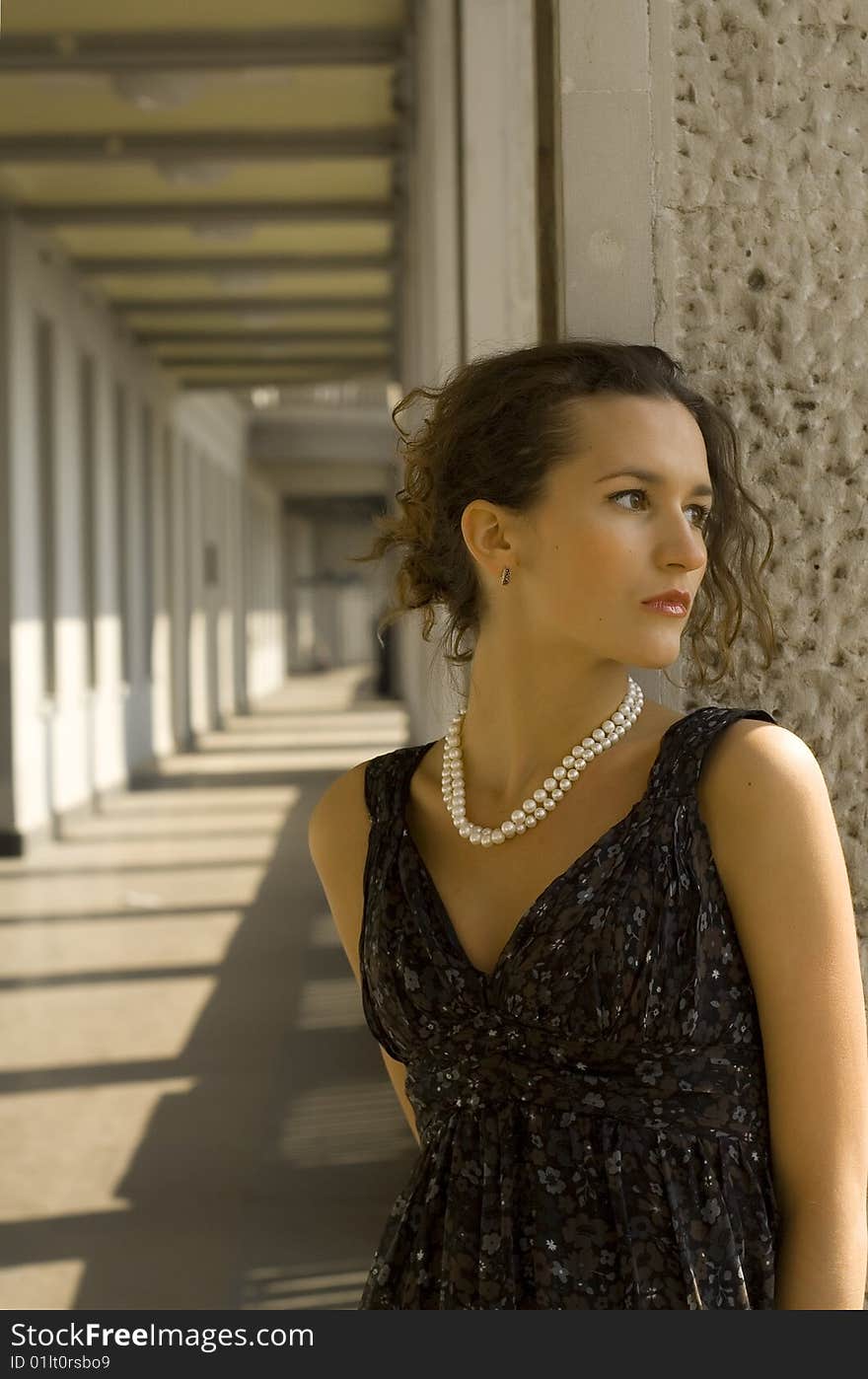 Young girl stands near a wall on a background a prospect. Young girl stands near a wall on a background a prospect