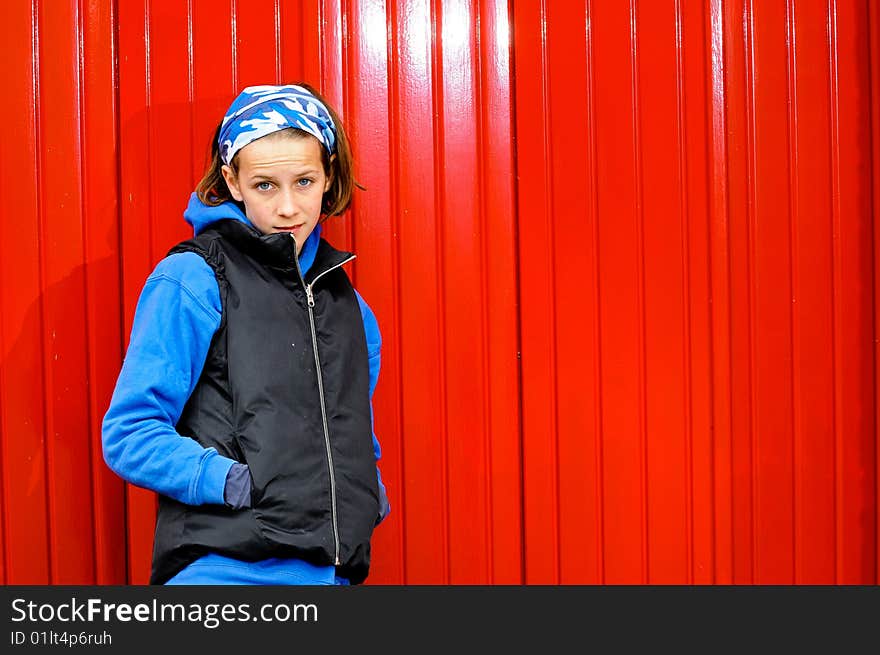 Teenage Girl Against Red Wall