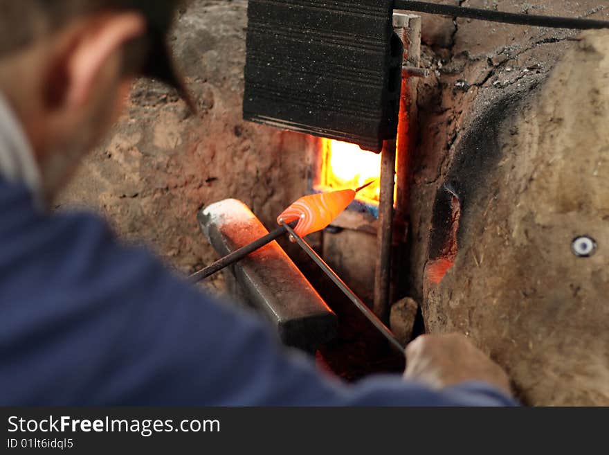 A man shaping a glass bead