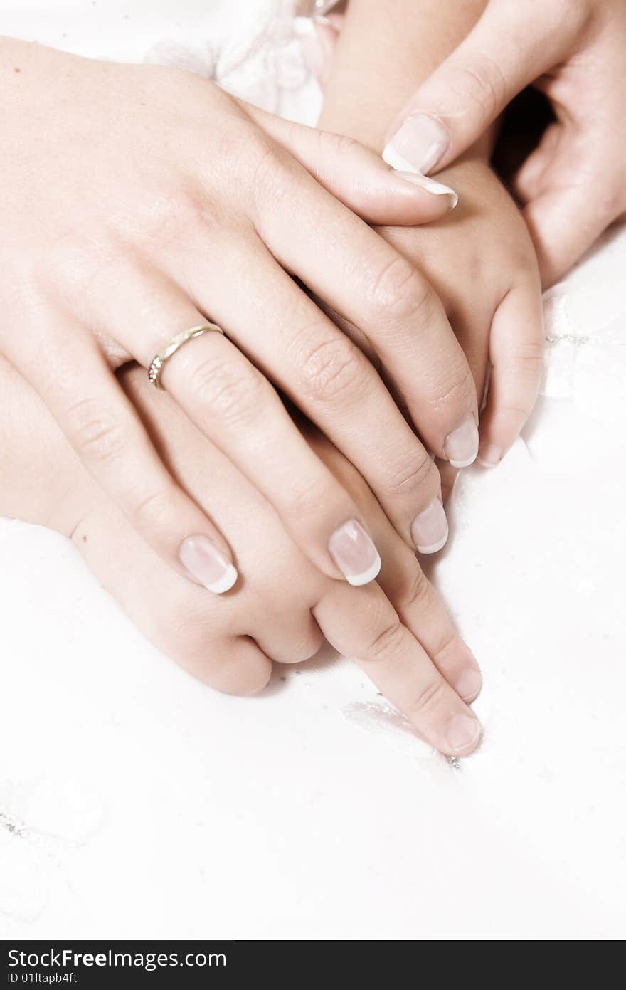 Bride and flower girl holding hands on lap. Bride and flower girl holding hands on lap