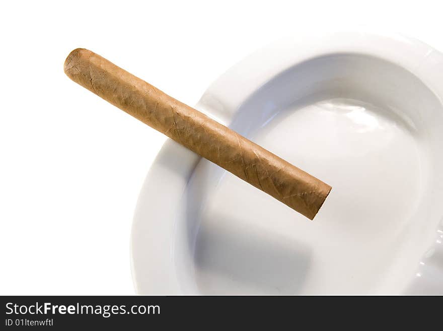 Dominican cigar on white ashtray