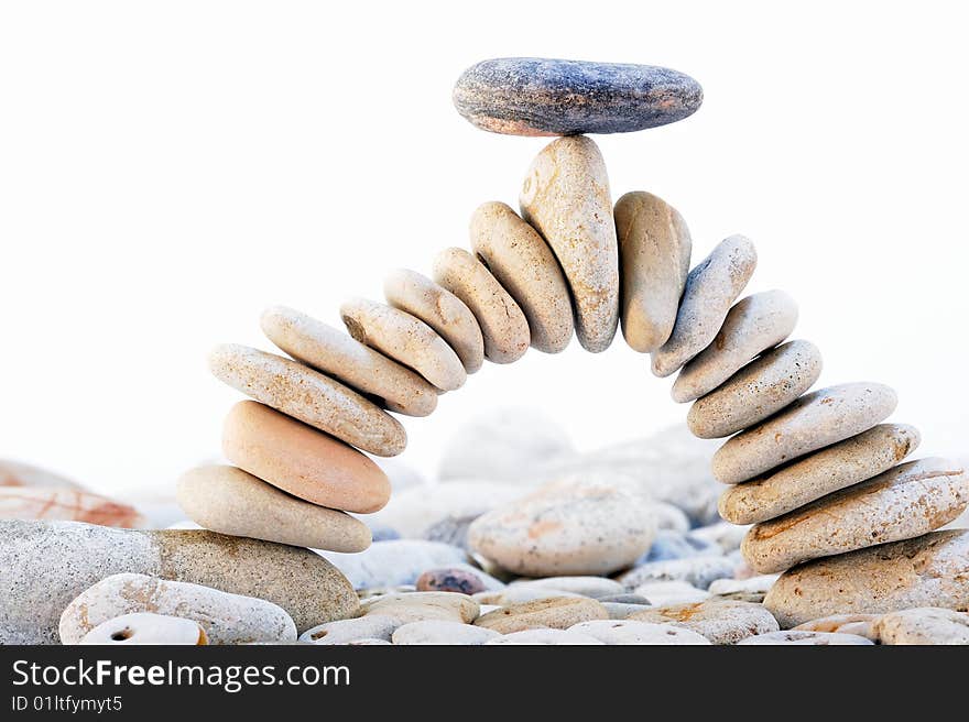 Arch of the pebbles with a black stone on top. Arch of the pebbles with a black stone on top