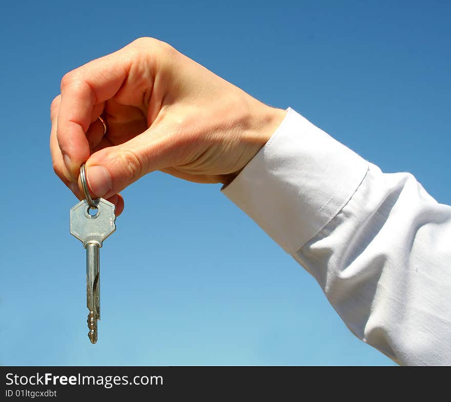 Key in a palm over white background