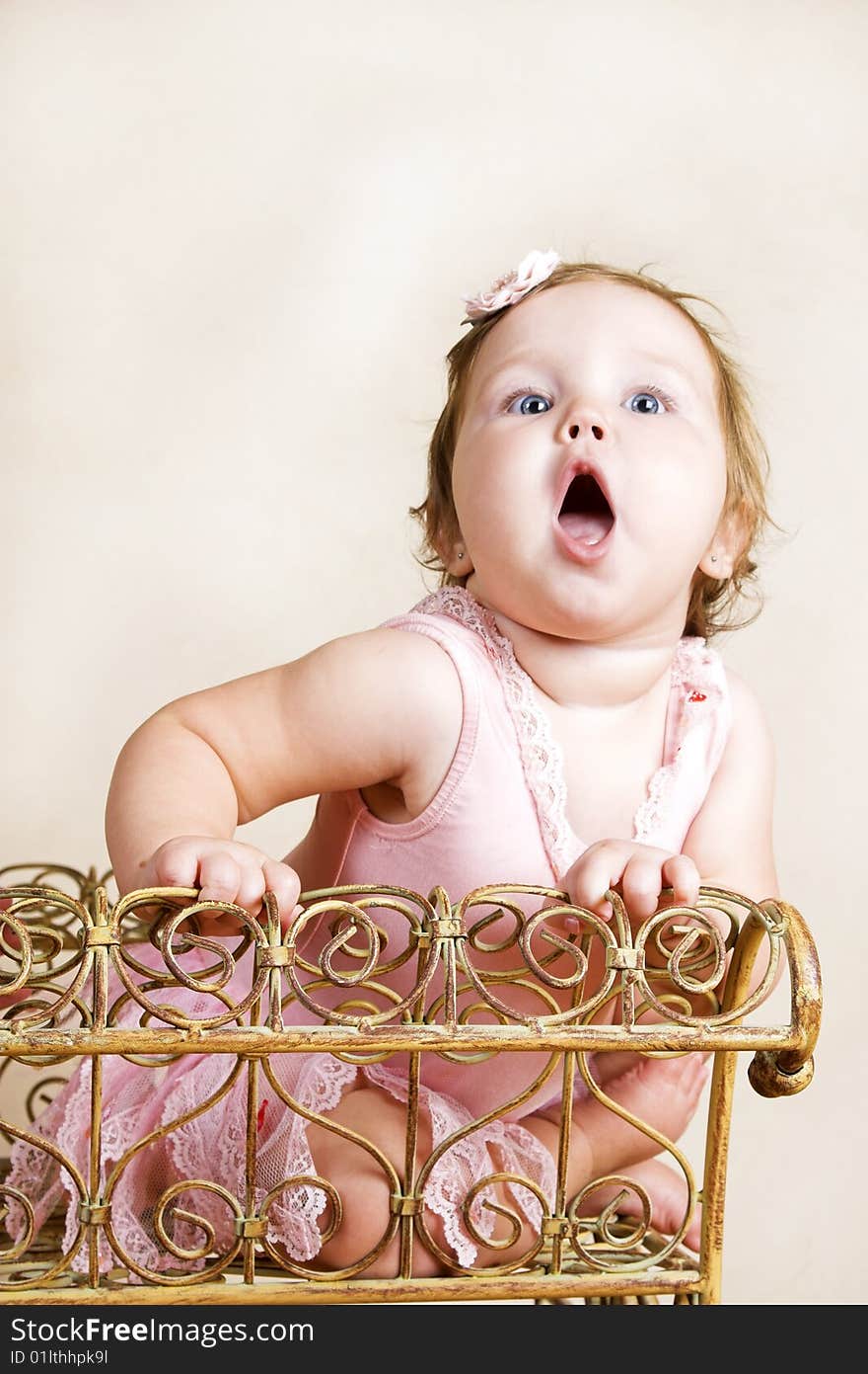 Little girl with short hair wearing a pink ballet outfit