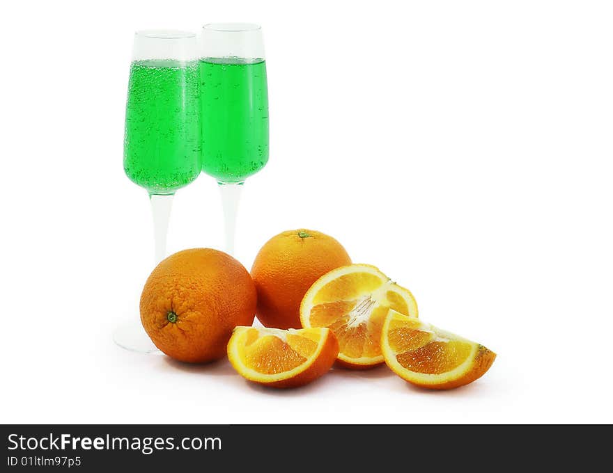 Oranges and glasses with green drink. Oranges and glasses with green drink