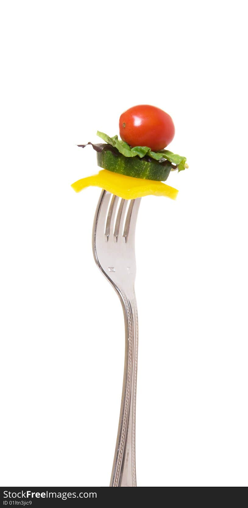 Bright, fresh salad vegetables on a fork ready for a tasty bite. Bright, fresh salad vegetables on a fork ready for a tasty bite