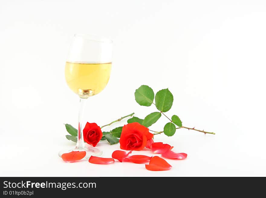 The glass with wine and roses isolated on white. The glass with wine and roses isolated on white