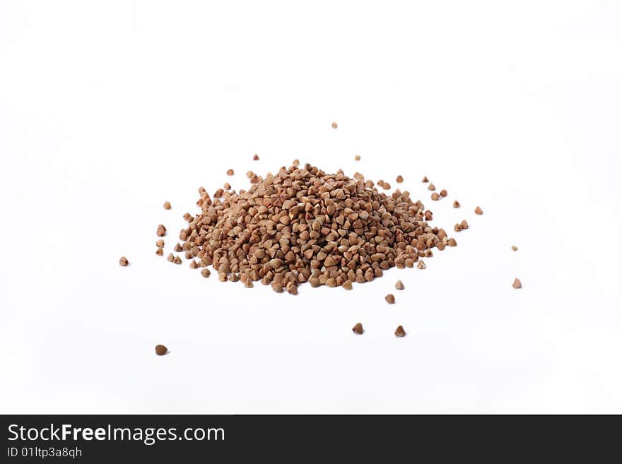 Isolated buckwheat on white background. Handful of grain