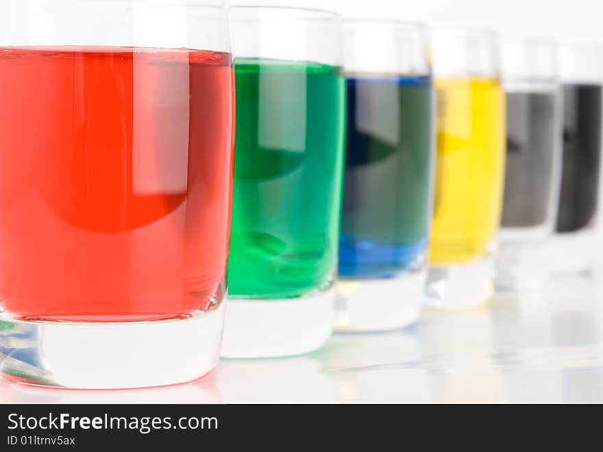 Glasses with colored water on white background. Glasses with colored water on white background