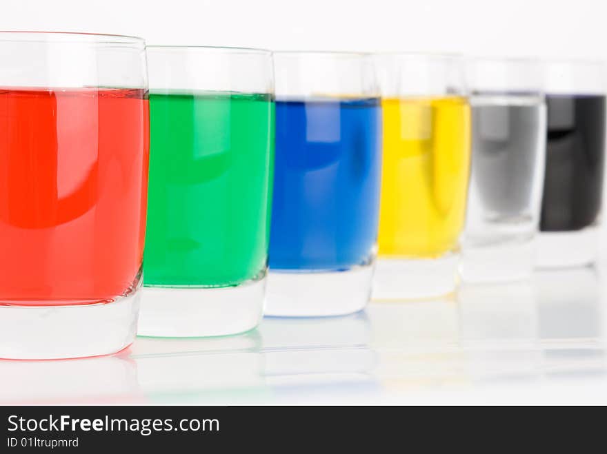 Glasses with colored water on white background. Glasses with colored water on white background