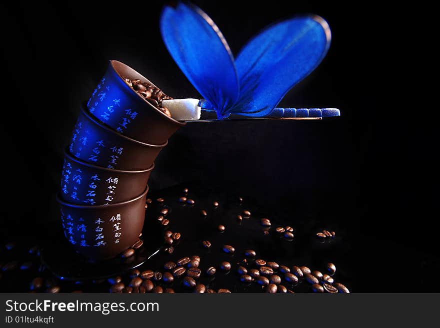 Balance - cups with beans of coffee, sugar and dragonfly