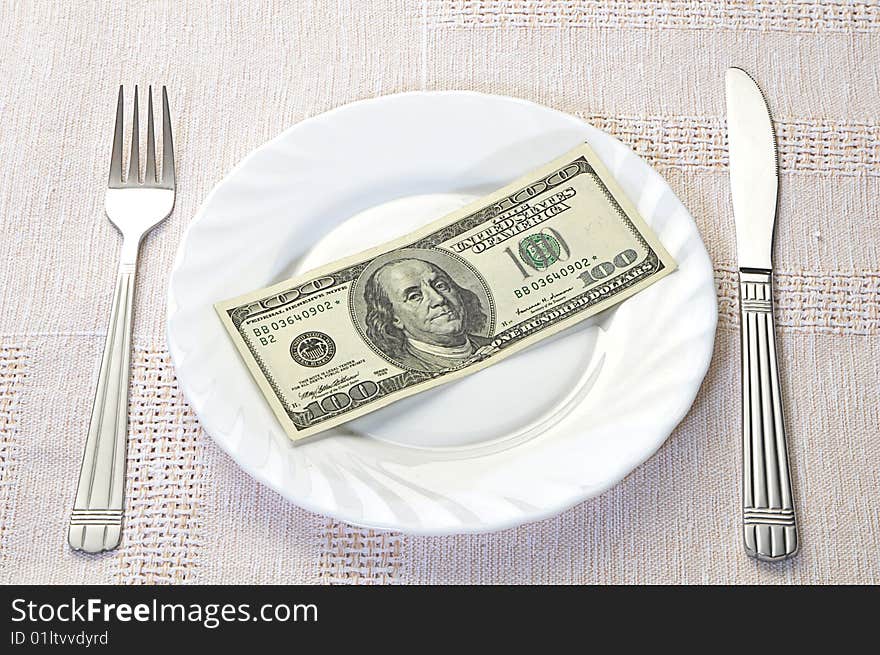 One handred dollars on white plate. One handred dollars on white plate