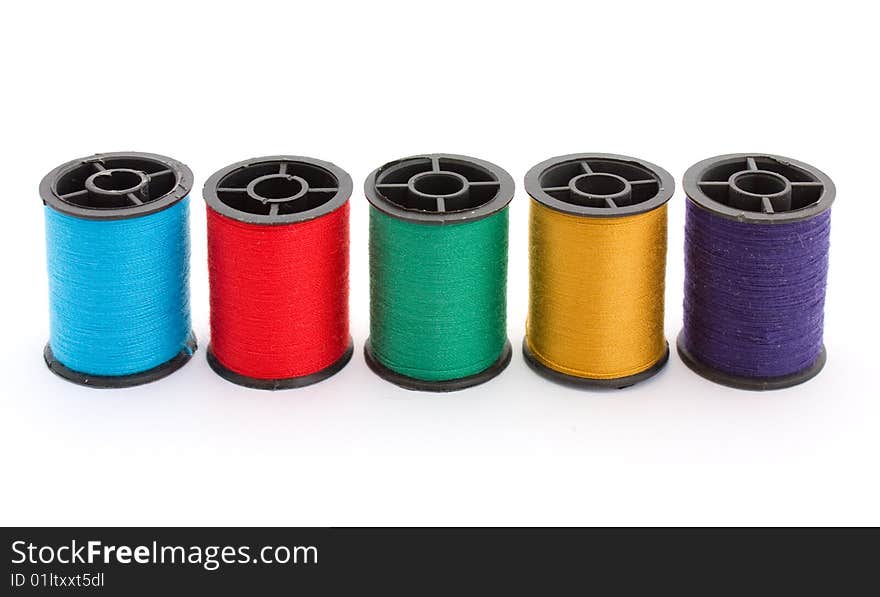 Five colouful bobbins with cotton thread. Five colouful bobbins with cotton thread