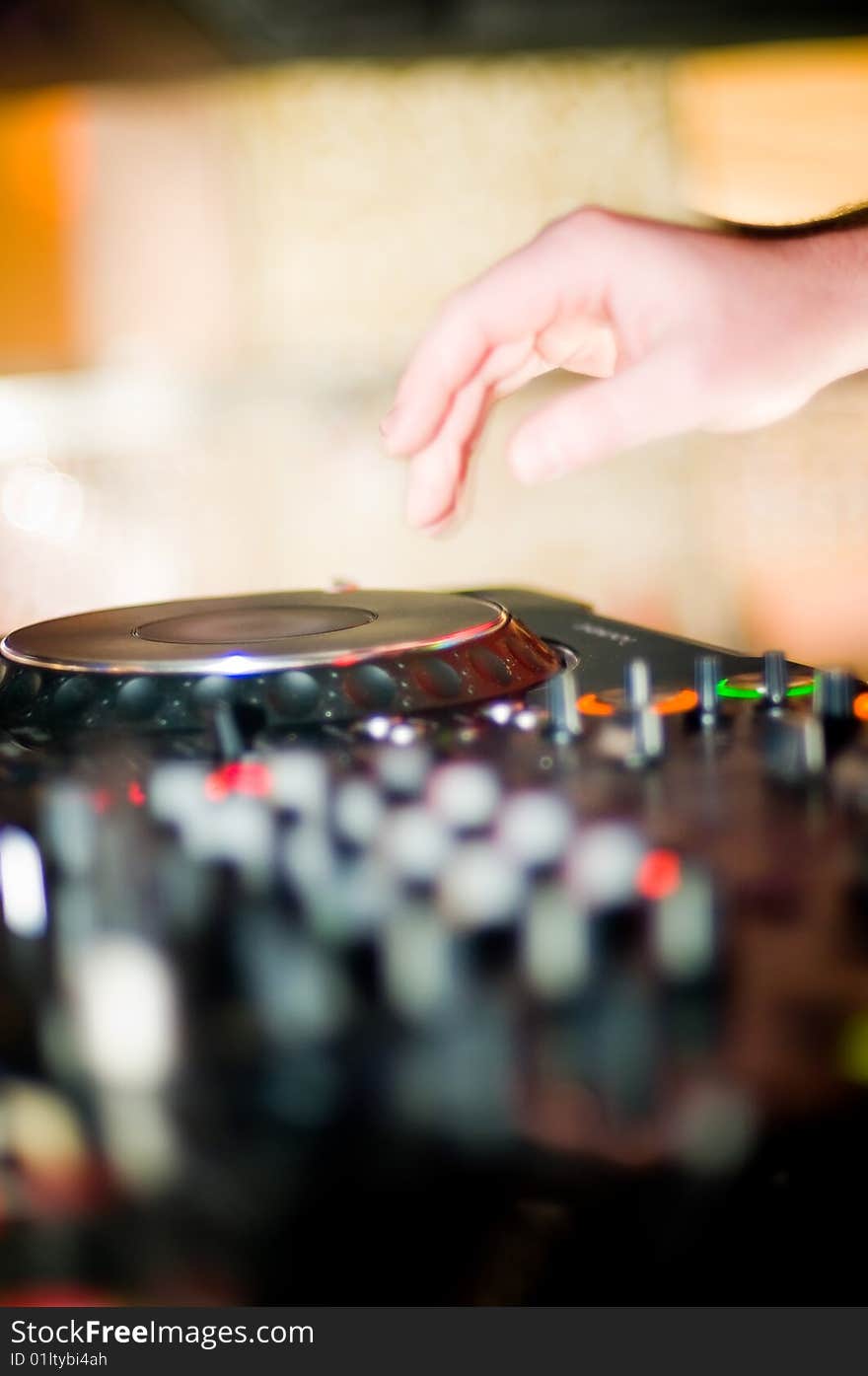 Close-up of deejay's hand and turntable, selective focus