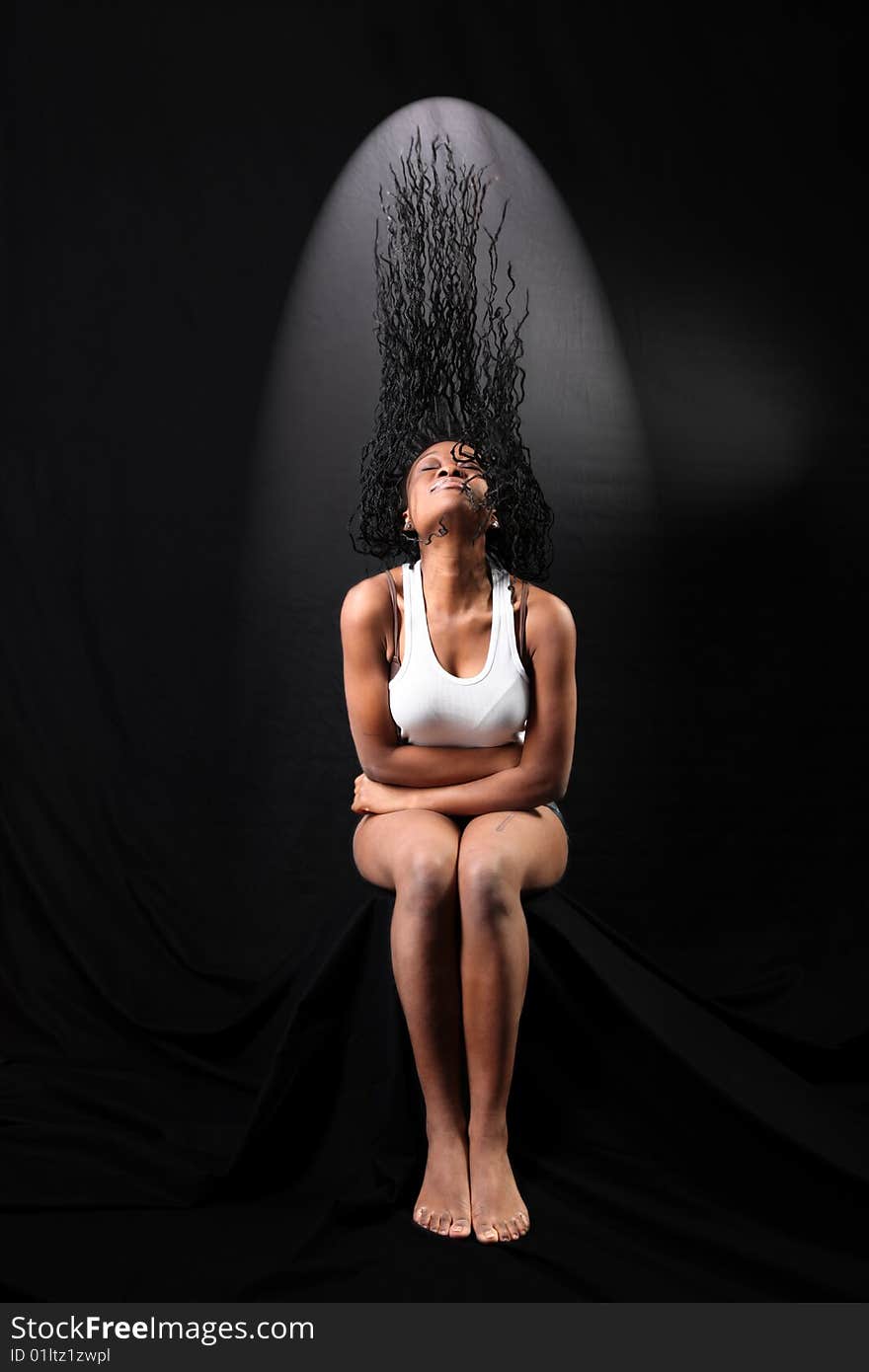 Fine art portrait of afro-american woman with long flapping hairs against black background. Fine art portrait of afro-american woman with long flapping hairs against black background