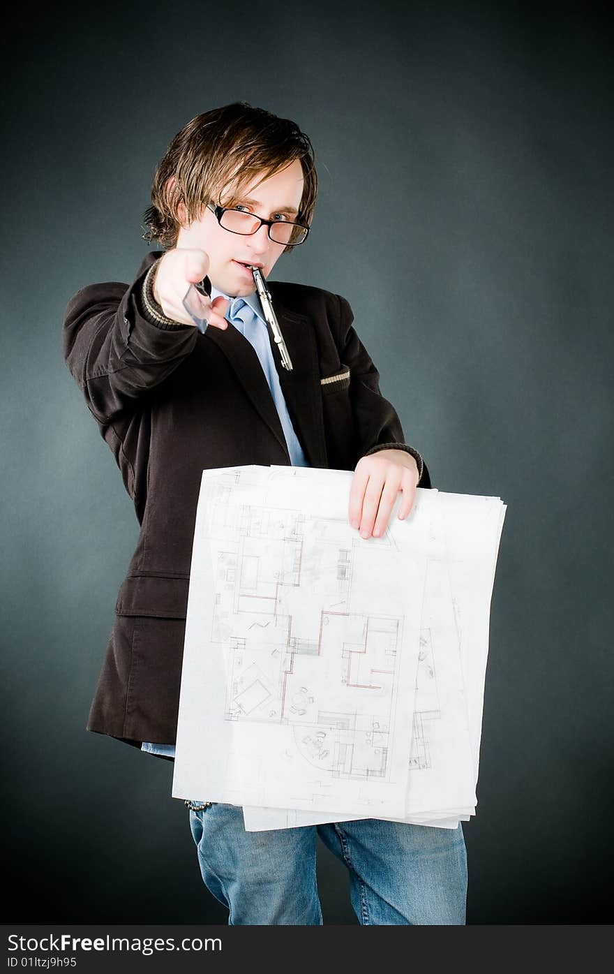 Young architect with sketch, studio shot