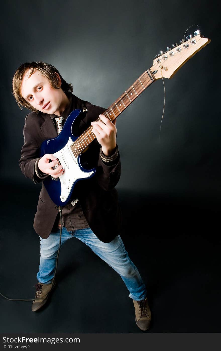 Young man playing electro guitar, high angle view