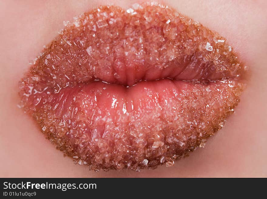 Woman's red lips coated with scattered sugar. Woman's red lips coated with scattered sugar