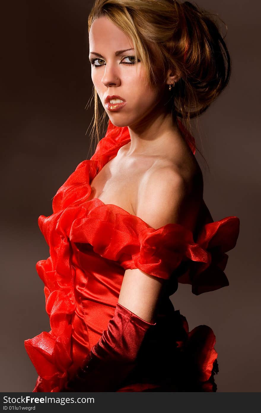 Pretty young girl wearing totally open red dress