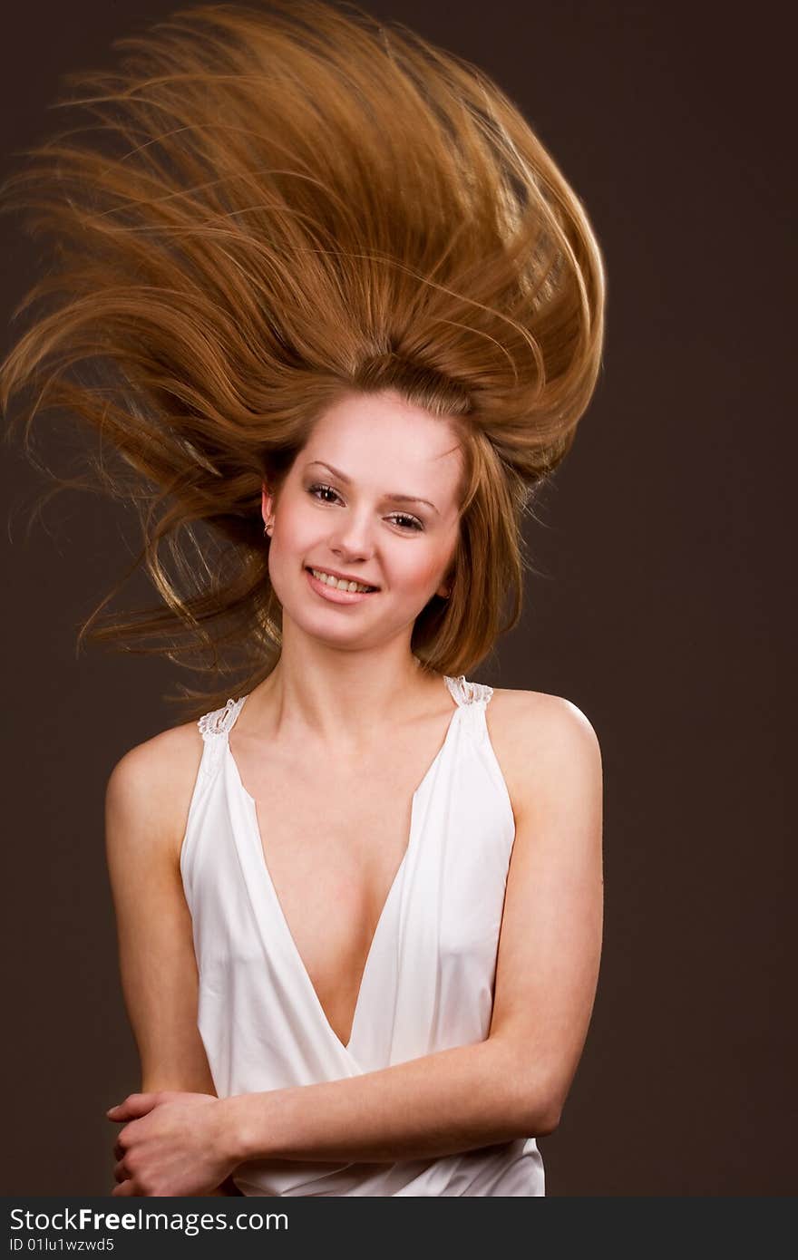 Happy young  girl with long flying hair