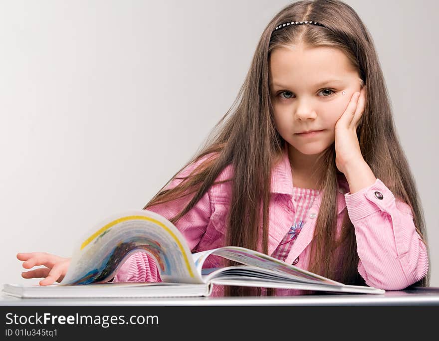 Happy little girl reading open book. Happy little girl reading open book