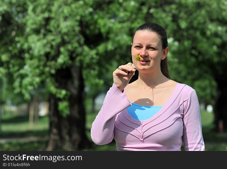 Young Attractive Female Smelling A Flower