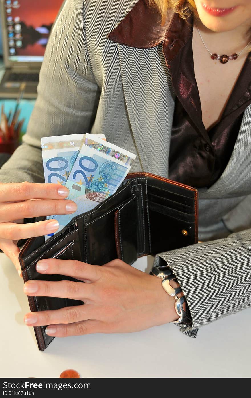 Young business woman, showing money taken from the wallet