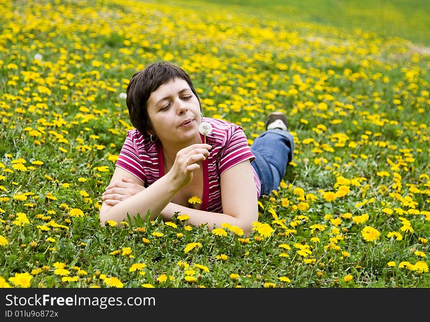 Young woman lying in a meadow