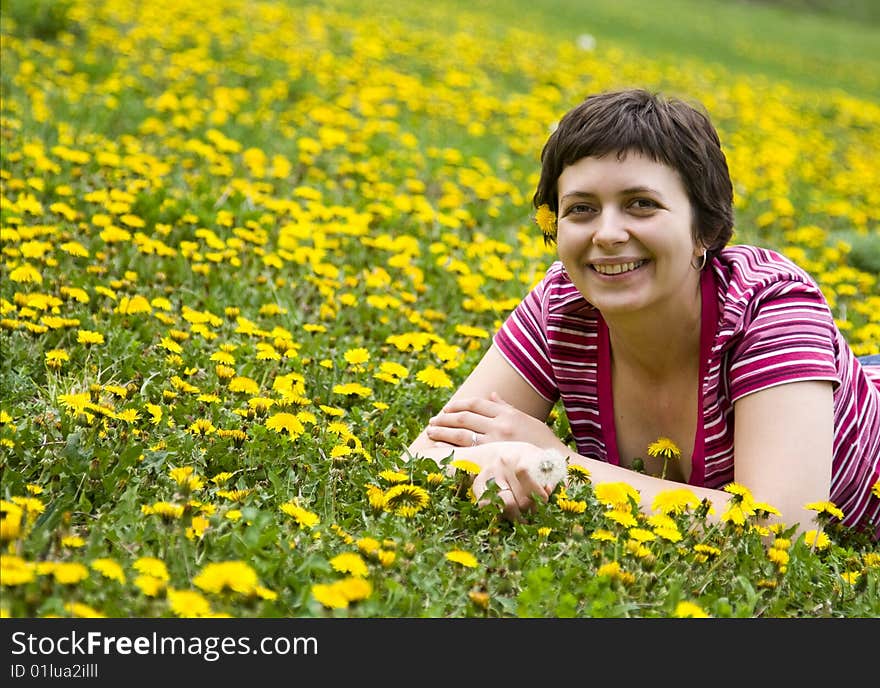 Young woman lying in a meadow